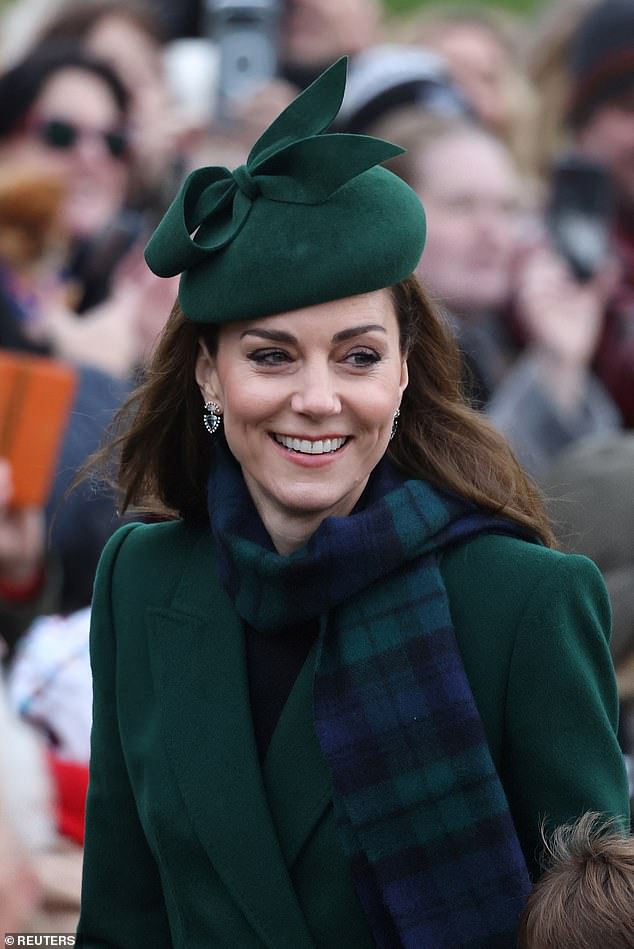 She paired a blue and green tartan scarf with her designer emerald coat