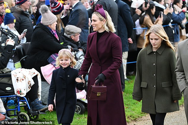 Zara Tindall wore a stunning plum coloured coat she paired with a hairband and purse of the same colour as she walked with her children