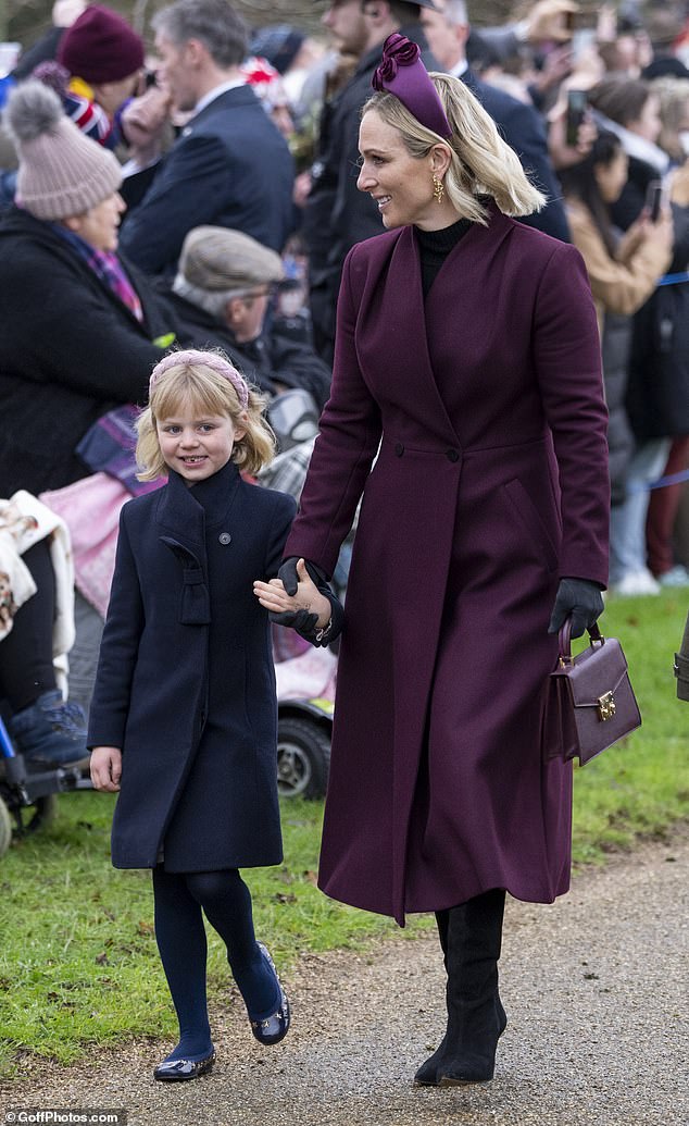 The youngster flashed a cheeky, toothy grin this morning outside the church