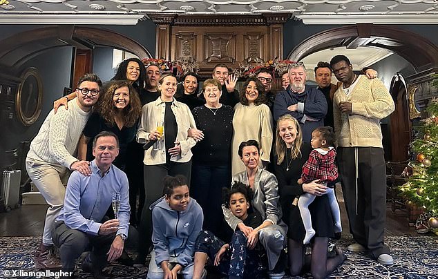 Liam can be seen grinning and waving in the back row of his festive snap alongside his fiancee Debbie Gwyther to the left. Right in front of them is Liam and Noel's mother Peggy. Liam and Noel's older brother, Paul Anthony Gallagher, can also be seen standing with his arms crossed on the right of the image