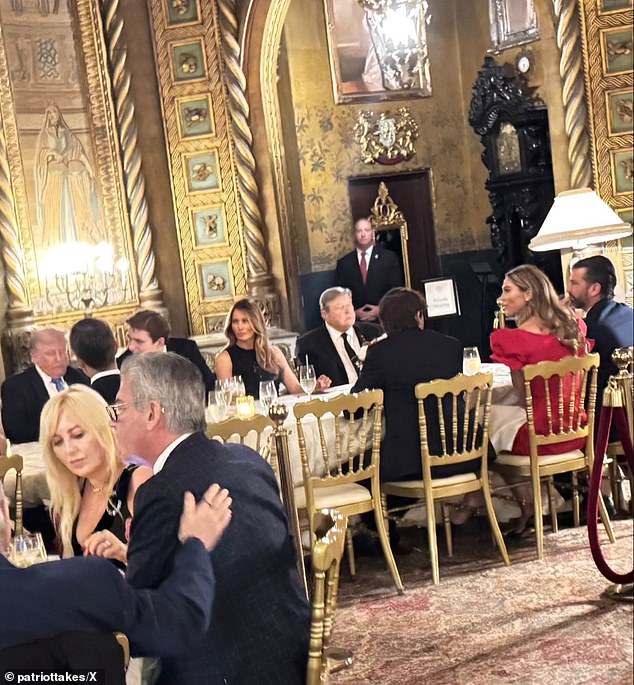 Donald Trump  Jr, 46, was pictured next to Bettina Anderson, 37, (in red) as the two dined with the rest of the president-elect's family on Christmas Eve in Palm Beach. President-elect Donald Trump is seen on the far left with his son Barron and wife Melania by his side