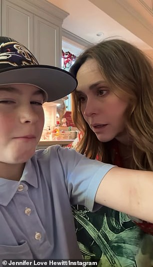 The youngster wore a collared blue shirt and Baltimore Ravens hat while snacking on pretzel sticks