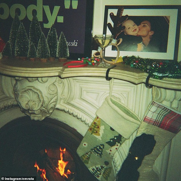 Emily placed mini trees as well as garland on the mantle, while two stockings hung above a roaring fire