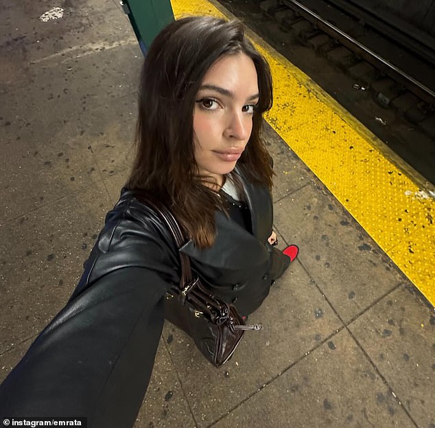 She gave a close look at her winter fashion as she snapped another selfie as she waited for the subway in Manhattan