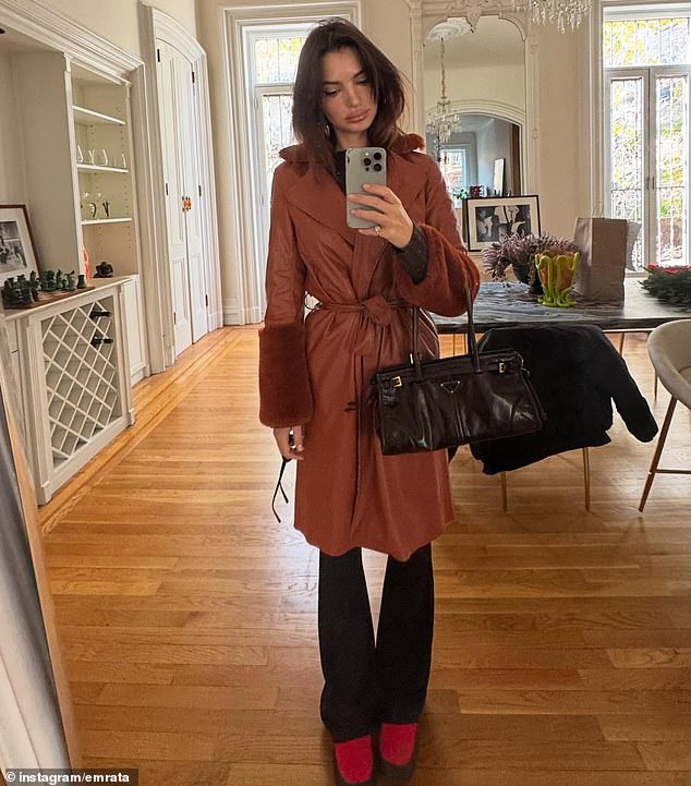 Before heading out for a daytime excursion, Emily posed for a mirror selfie in a brown, leather coat with a fuzzy trim