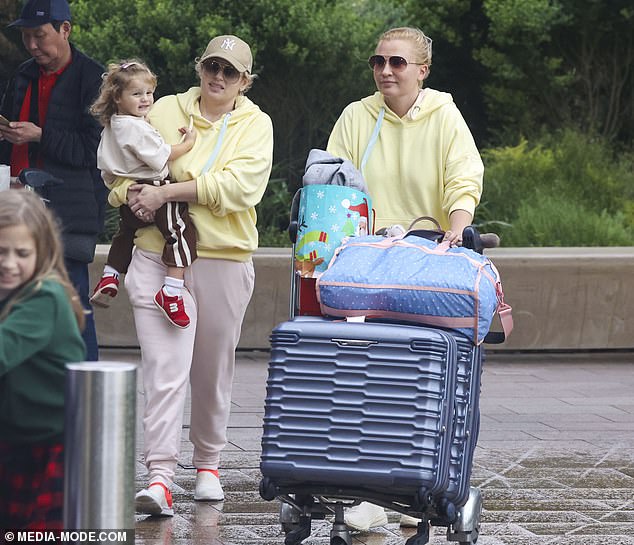 The couple's cherubic daughter could be seen smiling happily as she contentedly nestled close to mum