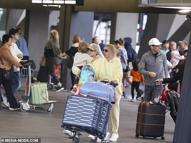 Her outfit differed thanks to a pair of equally comfortable-looking track pants that were a very similar shade to her jumper