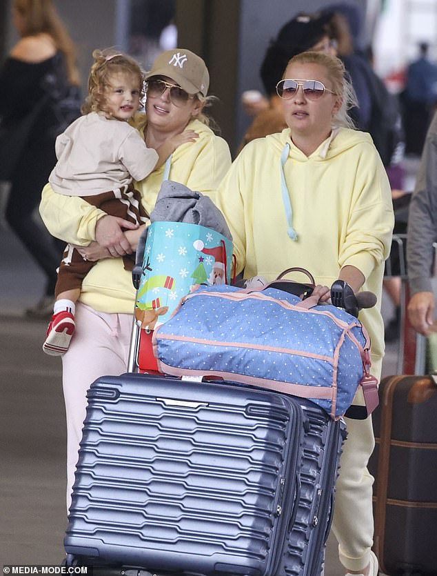 The Aussie actress, 44, and her bride, 40, were spotted arriving at Sydney Airport with daughter Royce, 2, in tow