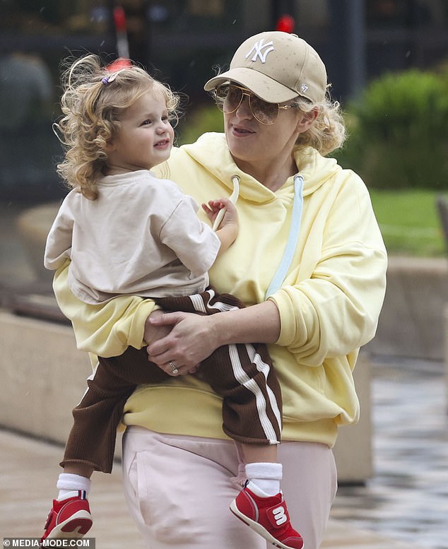 Rebel wore a loose-fitting lemon coloured hooded jumper that she matched with a pair of comfortable-looking light pink track pants