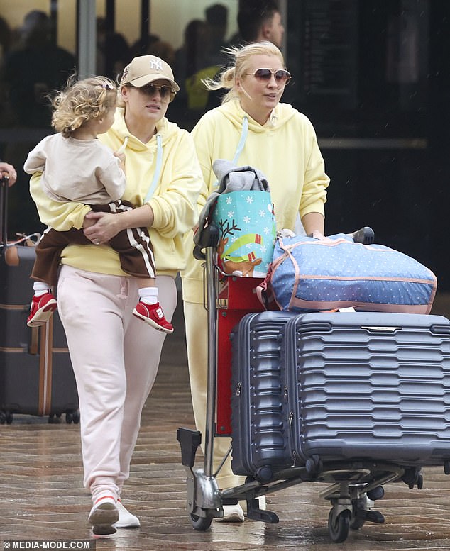 Rebel Wilson and wife Ramona Agruma were the personification of 'twinning' when they touched down in Australia on Friday. Both pictured