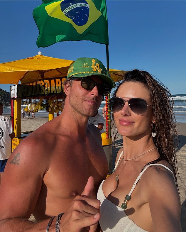 The Victoria's Secret model wore a textured white top with thin beaded straps and aviator sunglasses. Buck, an Australian jewelry designer, rocked a green Good Quality Human hat and went shirtless