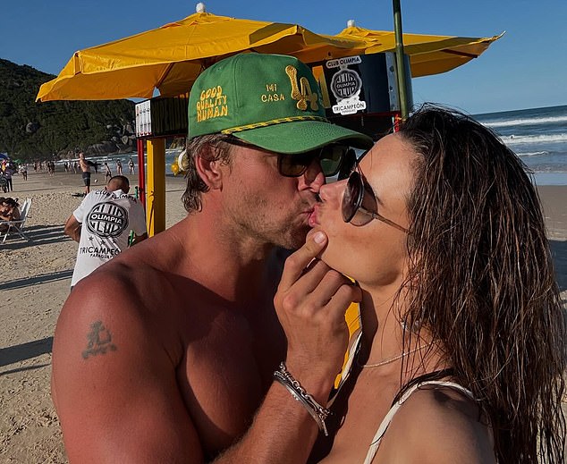 Alessandra Ambrosio, 43, looked totally loved up as she shared a smooch with her new boyfriend Buck Palmer in a photo posted to Instagram on Friday from Brazil