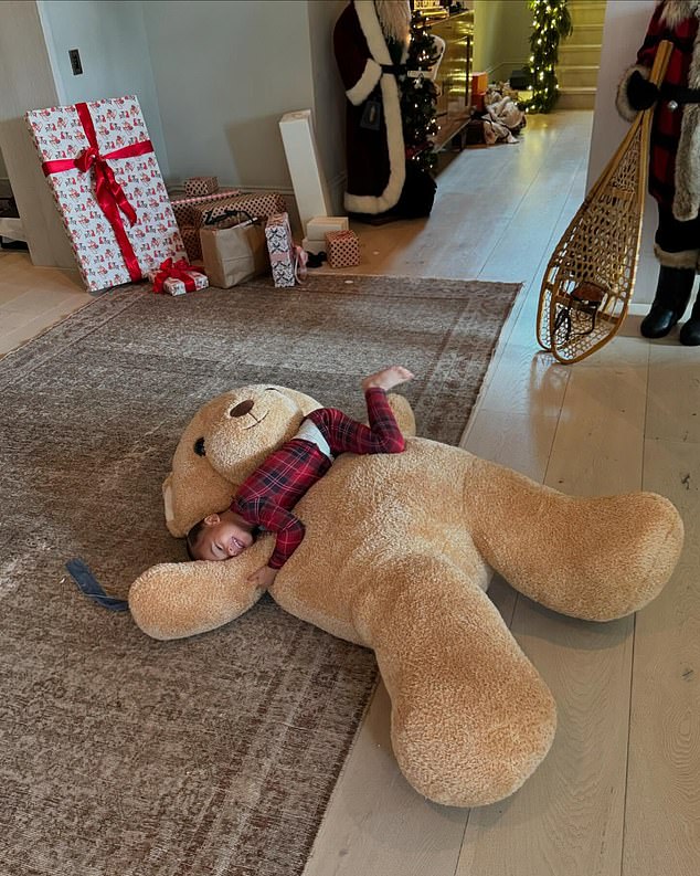 In another photo of the tot, Aire flashed a sweet smile while laying on a giant brown teddy bear in the foyer of Jenner's $60million Hidden Hills mansion