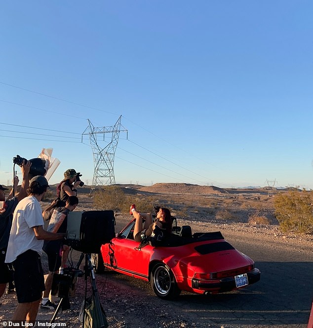 In the slew of snaps she also included this behind the scenes one of her posed on a convertible red car giving her fans an insight into what goes on with being a superstar