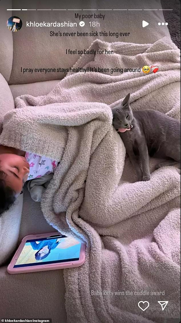 On Friday, the 40-year-old Good American co-founder took to her Instagram Story to report that the youngster is still sick. She shared a snap of True sound asleep on a couch while wrapped in a blanket with their pet cat, Baby Kitty, cuddled up beside her