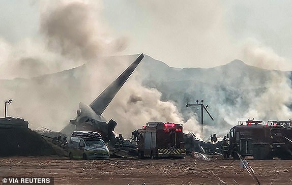 Firefighters carry out extinguishing operations on an aircraft which drove off runaway at Muan International Airport in Muan, South Jeolla Province, South Korea, December 29, 2024. Yonhap via REUTERS THIS IMAGE HAS BEEN SUPPLIED BY A THIRD PARTY. NO RESALES. NO ARCHIVES. SOUTH KOREA OUT. NO COMMERCIAL OR EDITORIAL SALES IN SOUTH KOREA.