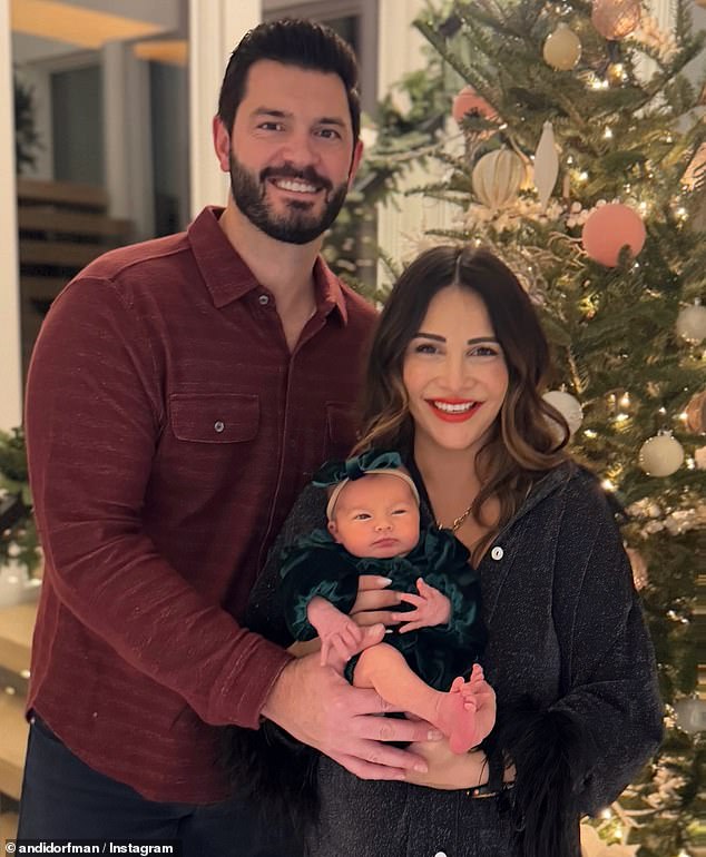 Andi shared an adorable snap as they posed with their baby girl while standing in front of a decorated tree