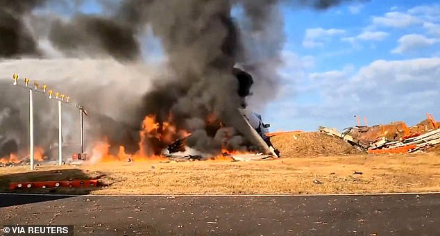 Firefighters carry out extinguishing operations on an aircraft which drove off runway