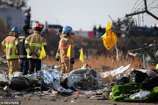 A life jacket hangs on fencing next to the wreckage of an aircraft at Muan International Airport - December 29, 2024