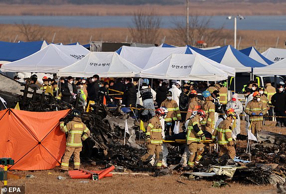 epa11796941 Firefighters carry out rescue operations at Muan International Airport in Muan, 288 kilometers southwest of Seoul, South Korea, 29 December 2024. According to the National Fire Agency, a passenger jet carrying 181 people erupted in flames after going off the runway at an airport in South Korea's southwestern county of Muan on 29 December, leaving at least 62 people dead.  EPA/HAN MYUNG-GU