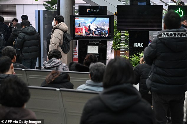 People and relatives of passengers of the crashed Jeju Air Boeing 737-800 series aircraft react at Muan International Airport in South Jeolla Province