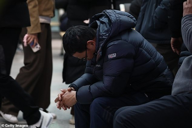 A relative of a passenger of the aircraft reacts at the Muan International Airport on December 29, 2024