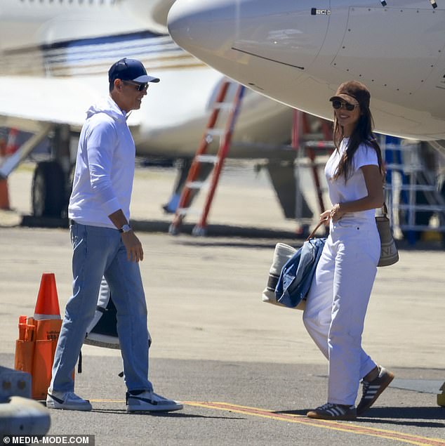 Protecting his eyes from the sun with a pair of dark shades, the American businessman took his sun safety seriously as he also pulled a blue cap down low over his face