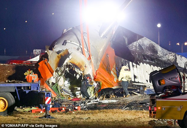 Firefighters and rescue personnel work near the scene where a Jeju Air Boeing 737-800 series aircraft crashed