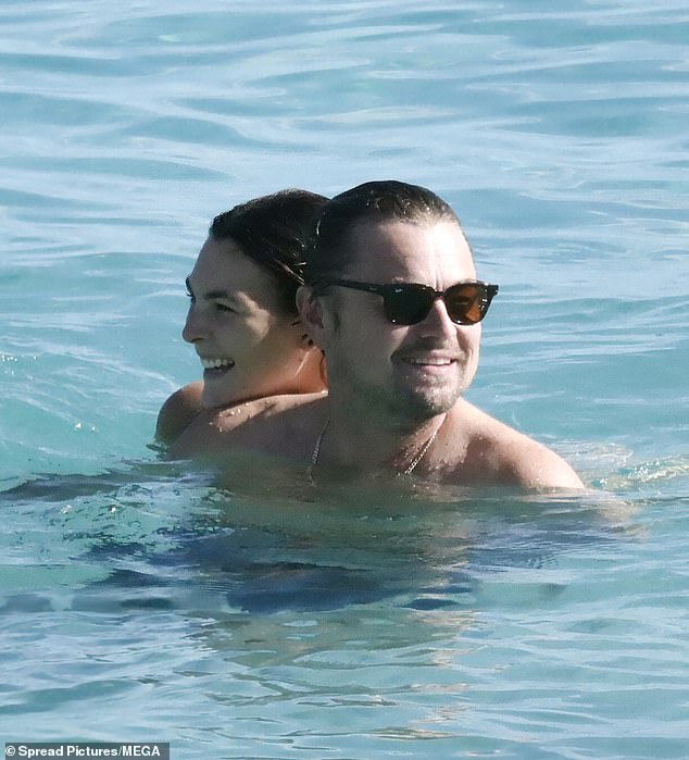 Leonardo DiCaprio beamed while taking a refreshing dip with his much younger girlfriend Vittoria Ceretti during their lavish Christmas getaway to Saint-Barthélemy Island in the Caribbean on Saturday