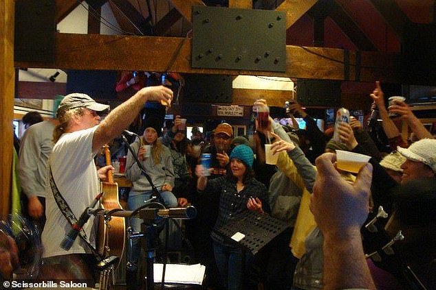 The Montana county of 127,880 surpassed popular college towns and party spots for the title of 'Drunkest County in America.' Pictured: People drinking at Scissorbills Saloon