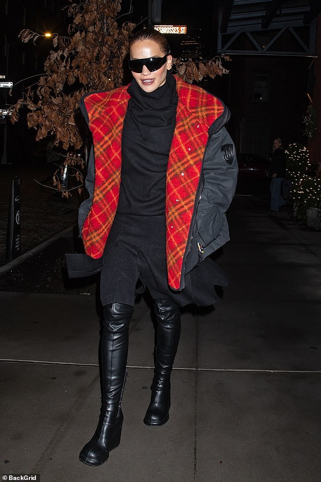 The singer, 34, was spotted in a striking black puffer coat that featured a red plaid lining as she made her way to Times Square where she will co-host Dick Clark's New Year's Rockin Eve with Ryan Seacrest