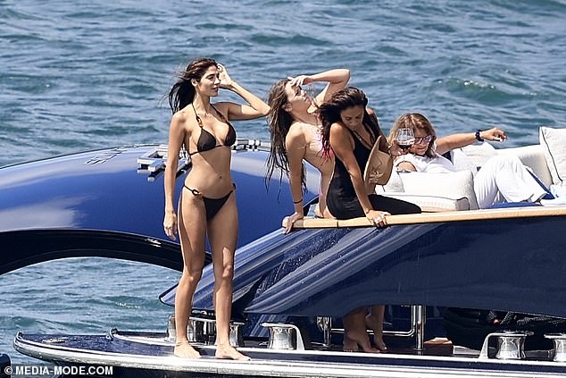 Pia (left) - aged 41, but with the body and complexion of a woman half her age - stripped down to her barely there swimwear for a scorching afternoon on the harbour