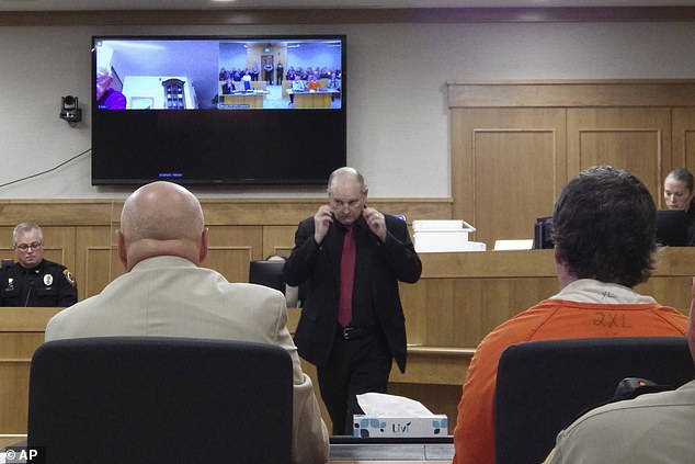 Ian Cramer, right, sits in court during his sentencing proceeding as Mercer County State's Attorney Todd Schwarz, center, returns to his seat in Stanton, North Dakota on Monday