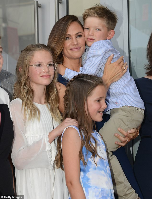 'Jen and Ben were all together for Christmas. It's all for the kids,' a source shared. 'Jen grew up surrounded by her family for the holidays, and she wants the same for her kids'; she is seen with their kids Violet, 19, Fin, 15, and Samuel in 2018