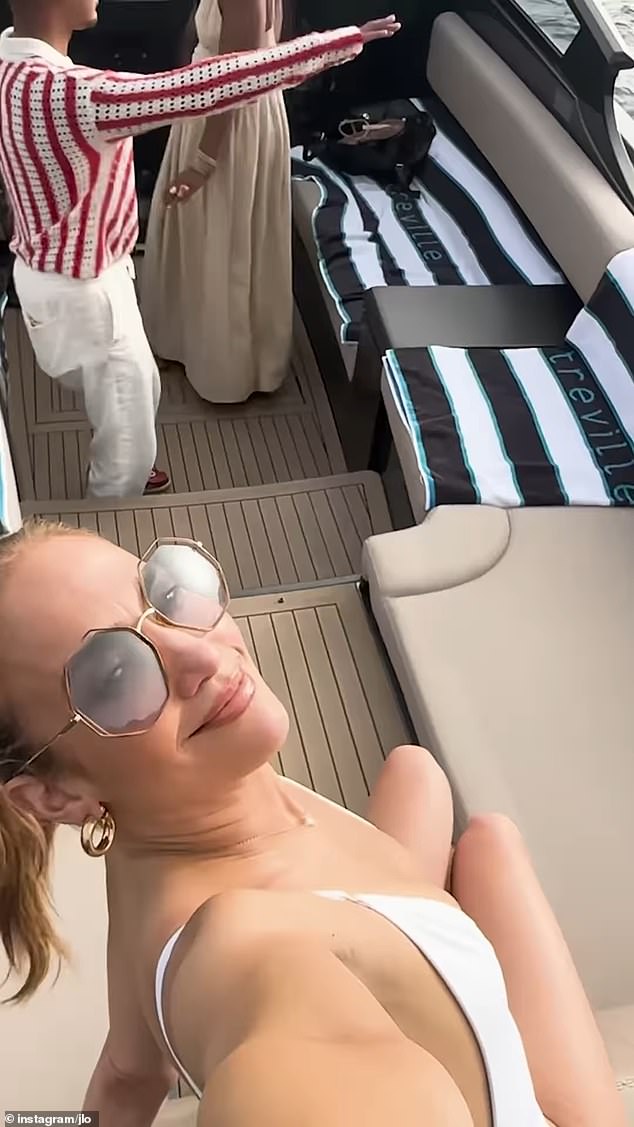 One clip saw her on a boat in a white swimsuit