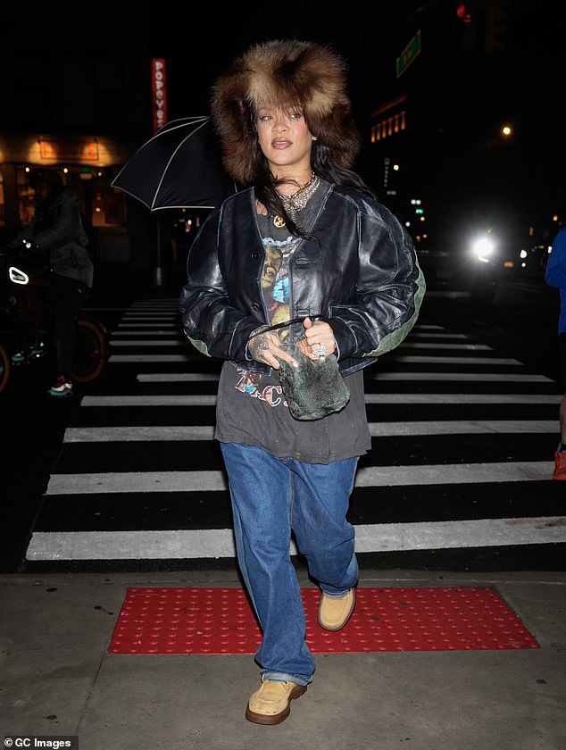 At the event Rihanna rocked an oversized fur hat, graphic Tupac shirt, jeans, and Bottega Veneta boots retailing for $1,400