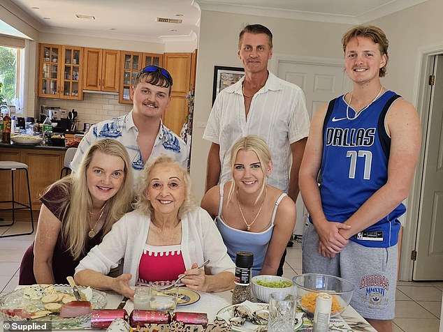 Ms Spinks with her family who she said had helped her pay around a quarter of a million dollars on treatments since she got the Covid vaccines