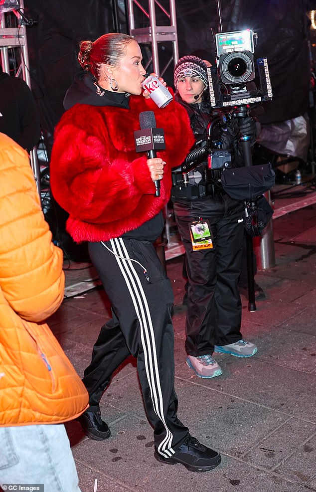 Earlier in the event, the performer matched her red coat with a more relaxed ensemble as she stepped out in a pair of Adidas tracksuit bottoms