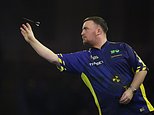 Luke Littler of England throws his dart during the semifinal match against Stephen Bunting of England, at the World Darts Championship in London, Thursday, Jan. 2, 2025. (AP Photo/Kirsty Wigglesworth)