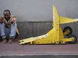 Jovon Bell from New York, who said he was injured in the New Year's attack, reacts near a temporary barriers set up in the French Quarter, Thursday, Jan. 2, 2025, in New Orleans. (AP Photo/George Walker IV)