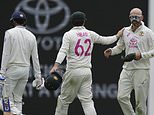 Australia's Nathan Lyon, right, is congratulated by Travis Head after taking the wicket of India's Shubman Gill, left, during play on the first day of the fifth cricket test between India and Australia at the Sydney Cricket Ground, in Sydney, Australia, Friday, Jan. 3, 2025. (AP Photo/Mark Baker)