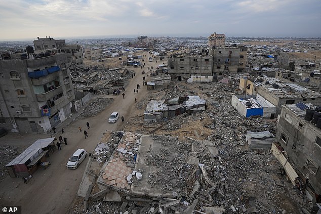 A tent camp for displaced Palestinians is set up amid destroyed buildings in the Khan Younis refugee camp