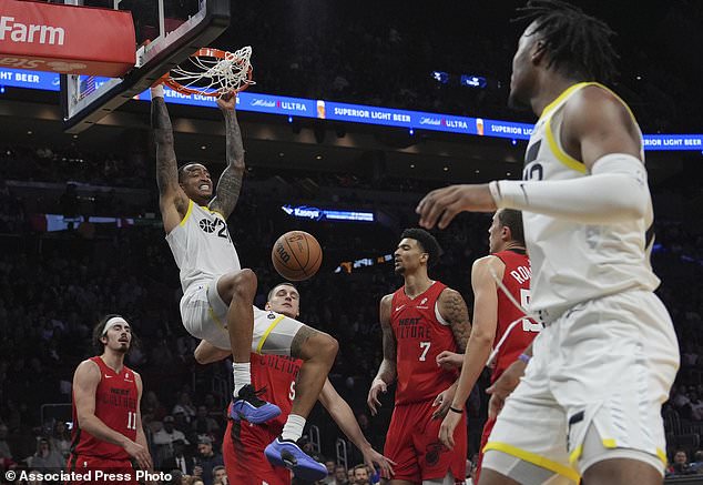 Utah Jazz forward John Collins (20) dunks during the second half of an NBA basketball game against the Miami Heat, Saturday, Jan. 4, 2025, in Miami. (AP Photo/Lynne Sladky)