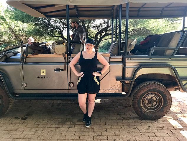 Kathryn poses with a safari jeep while on holiday with a family in South Africa