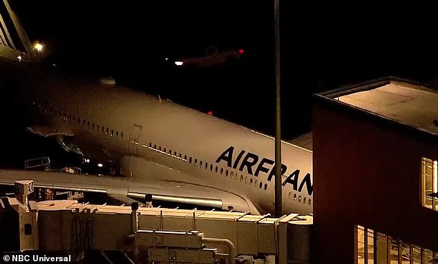 A passenger has died on board Air France flight from Paris to Boston despite a doctor trying to save them. The plane is picture at Logan airport last night