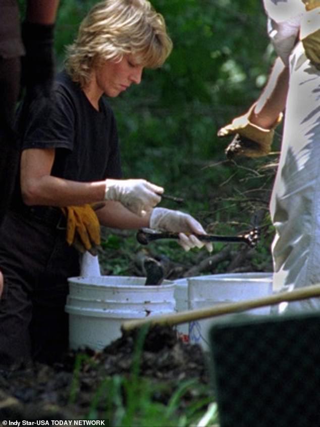 A lab technician with the Hamilton County Sheriff's Department examines human bones in the woods around Fox Hallow Farm during the original 1996 investigation