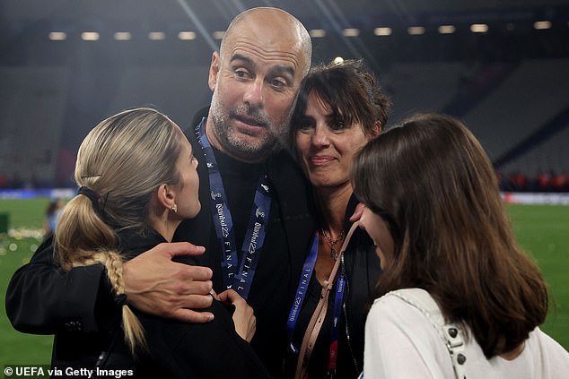 Guardiola, pictured with his wife and daughters, signed a two-year extension in November