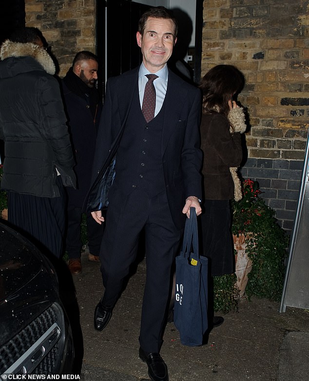 Comedian Jimmy Carr was also present in a navy three-piece suit with a red tie and light blue shirt. He held a tote bag as he exited the venue