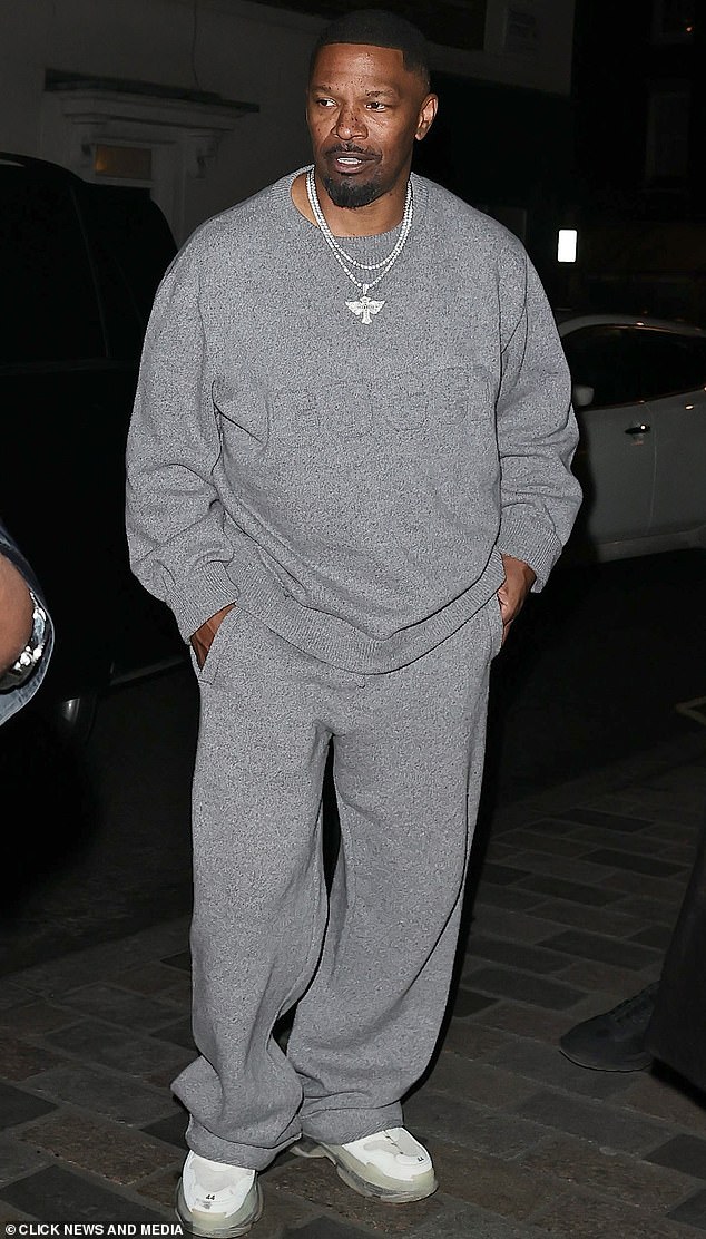 The actor, 57, wore a baggy grey Gucci Jumper with matching tracksuit bottoms, completing the look with white trainers with a lime gum sole and a statement silver chain