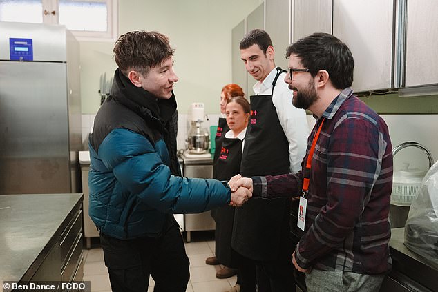 The Peaky Blinders favourite was seen busy meeting with young care leavers and care leavers with learning disabilities - who were preparing to serve lunch at the British Ambassadors Residence